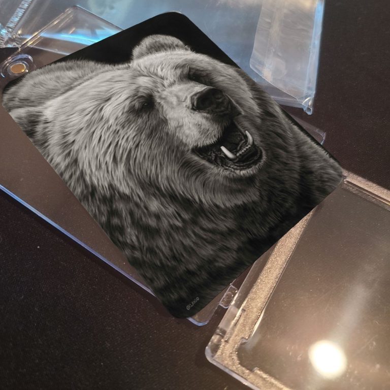 Black and white close-up of a smiling bear's face.
